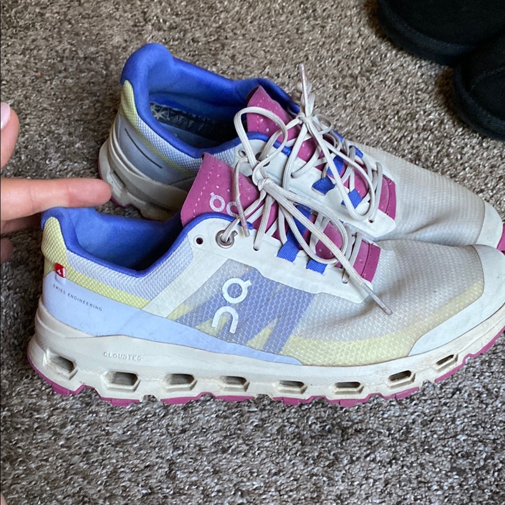 On Running White and Purple Athletic Shoes with CloudTec Technology